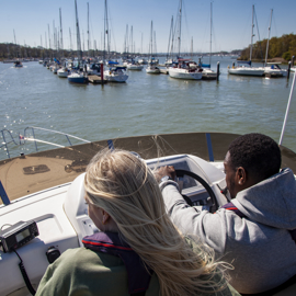 birdseye view of couple steering a powerboat