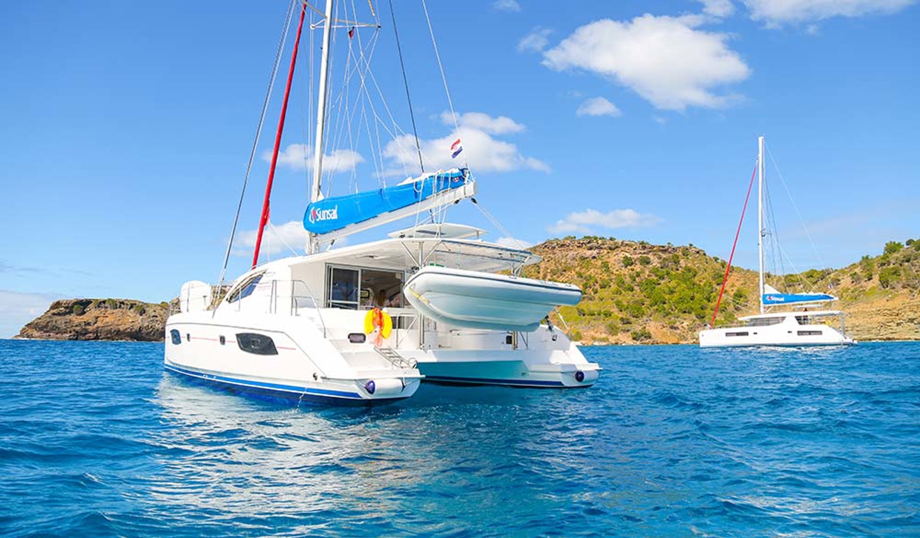 couple of sunsail yachts anchored in the ocean