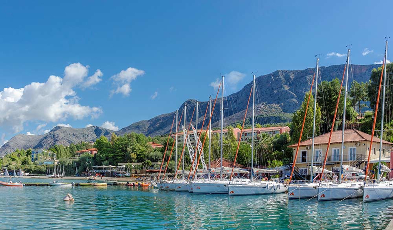 numerous boats lined up and moored at harbour