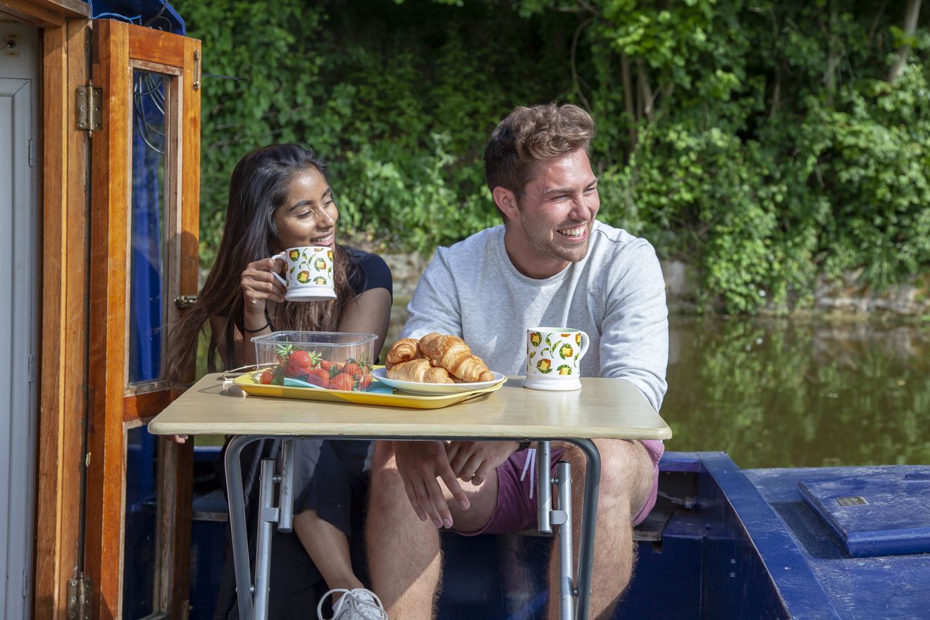couple enjoying a cup of tea on narrowboat
