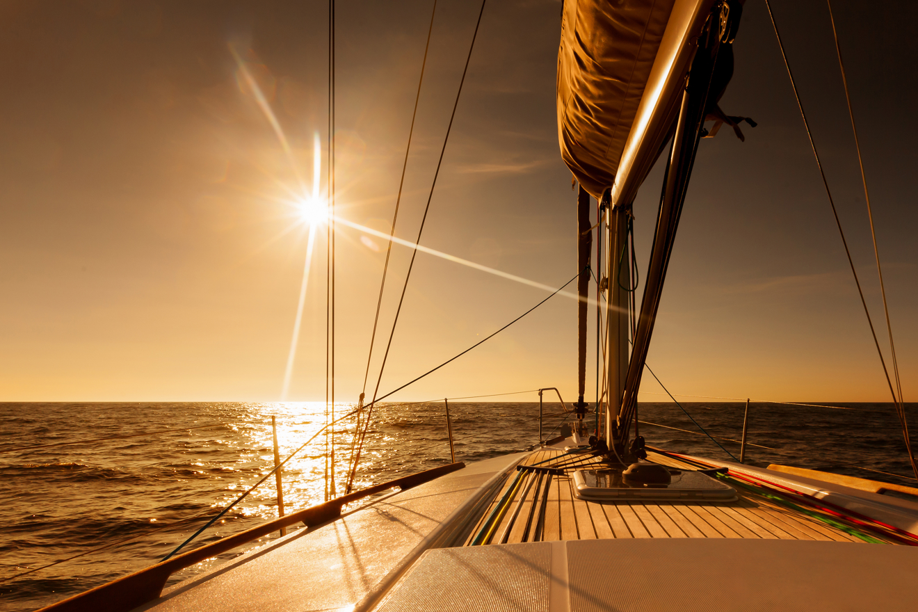 yacht sailing through sunset waters