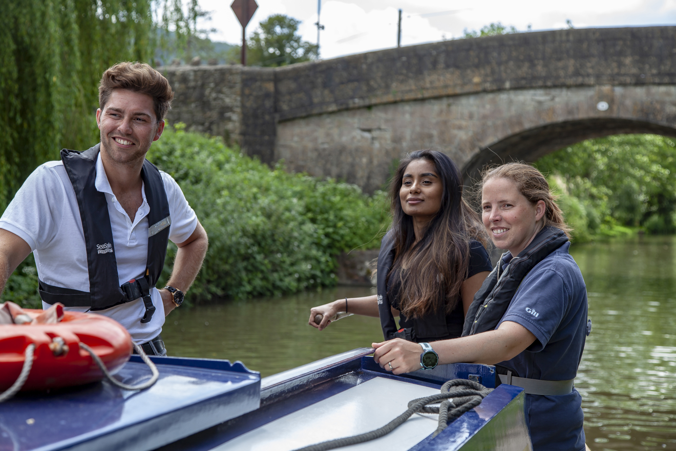 Man and two women on a canal boat on the inland waterways