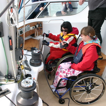 people in wheelchairs preparing their yacht