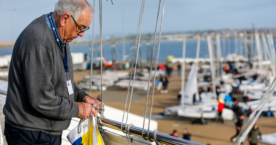 Volunteer adjusting sails for dinghy