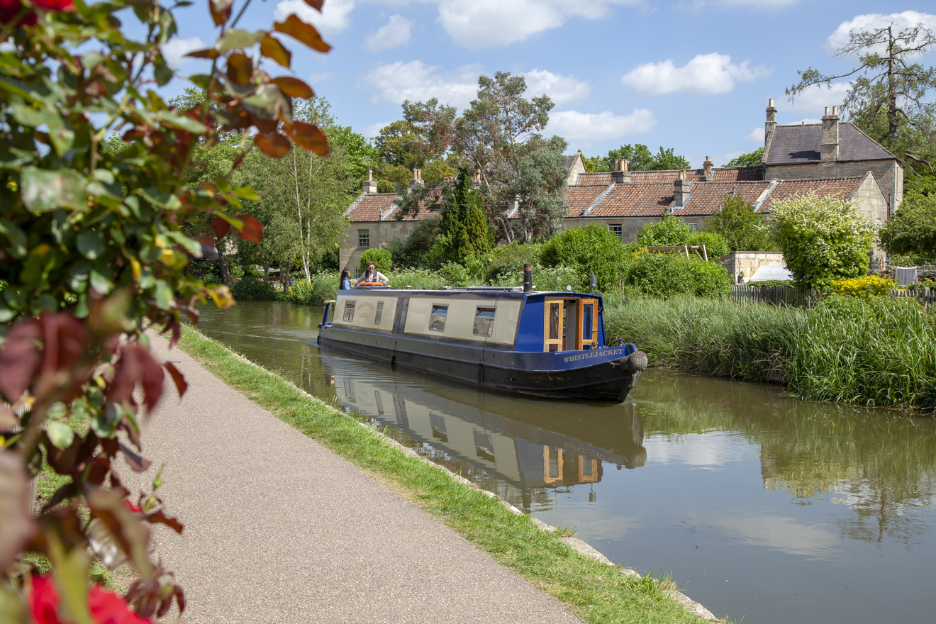 narrow boat slowly navigating through the water