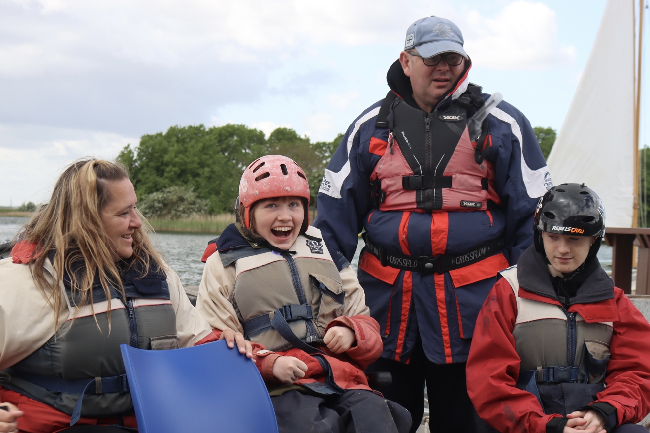 Grace and her family smiling on a boat