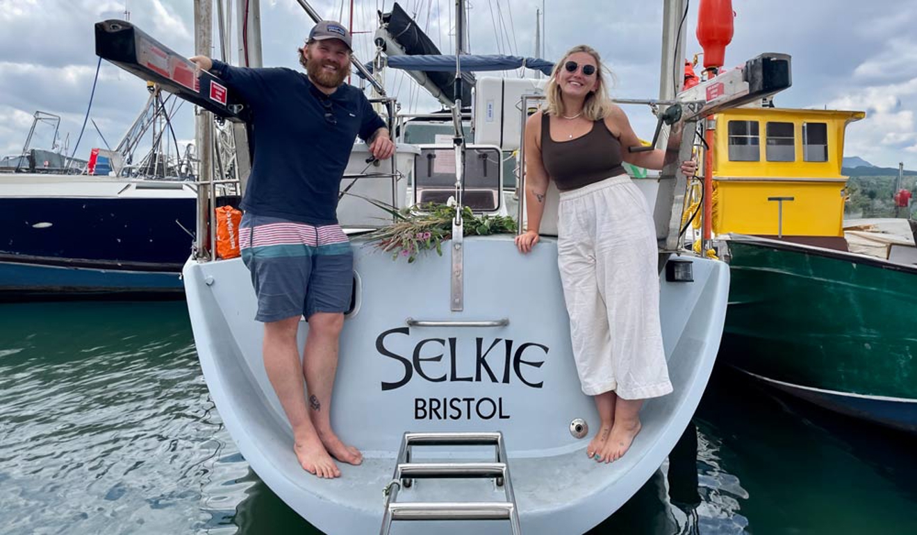 2 people standing on the stern of the boat