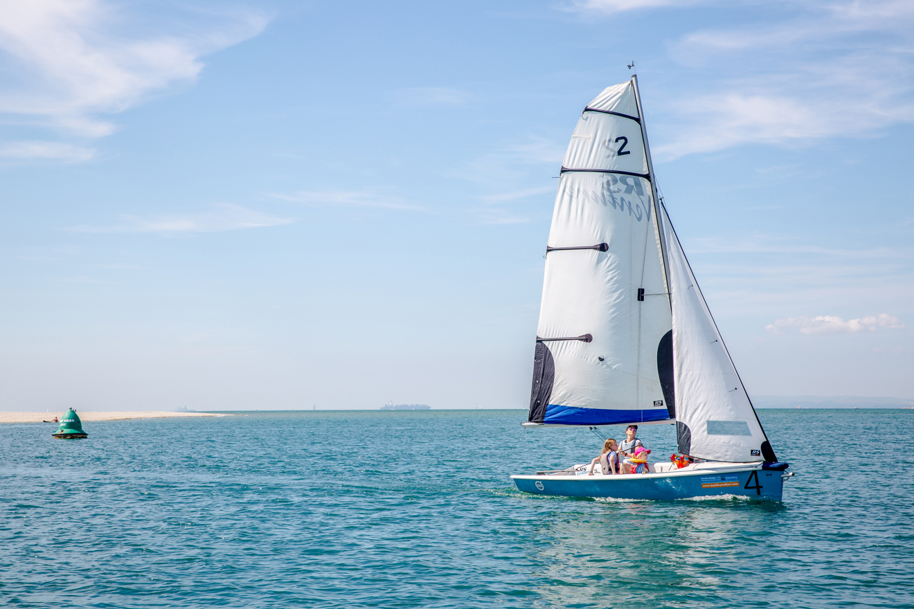 RS dinghy travelling through calm waters on a spring day