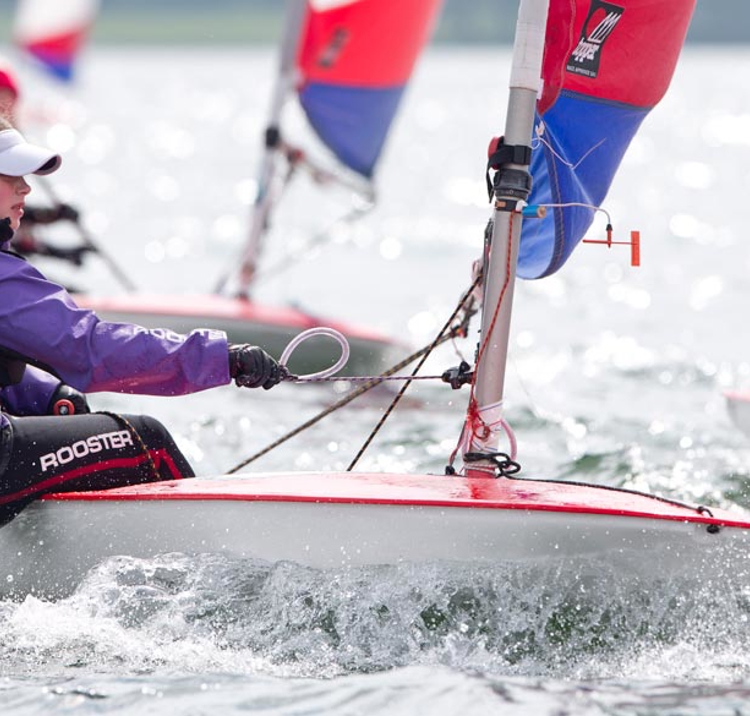 close up of young woman sailing on a dinghy