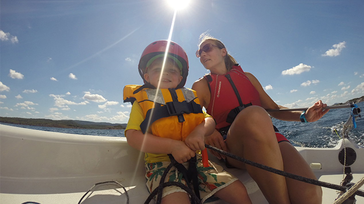 Mid shot of two women sat on a boat