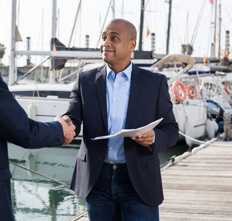 Boat owner handing over paper work for inheriting a boat or passing a title 
