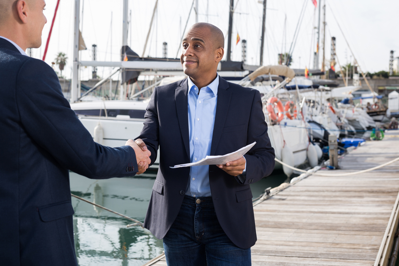 Boat owner handing over paper work for inheriting a boat or passing a title 