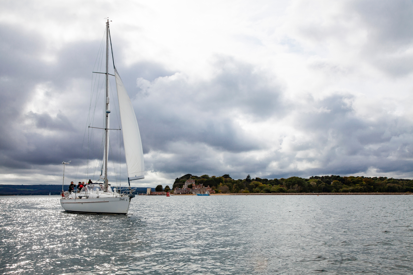wide shot of boat sailing through winter waters