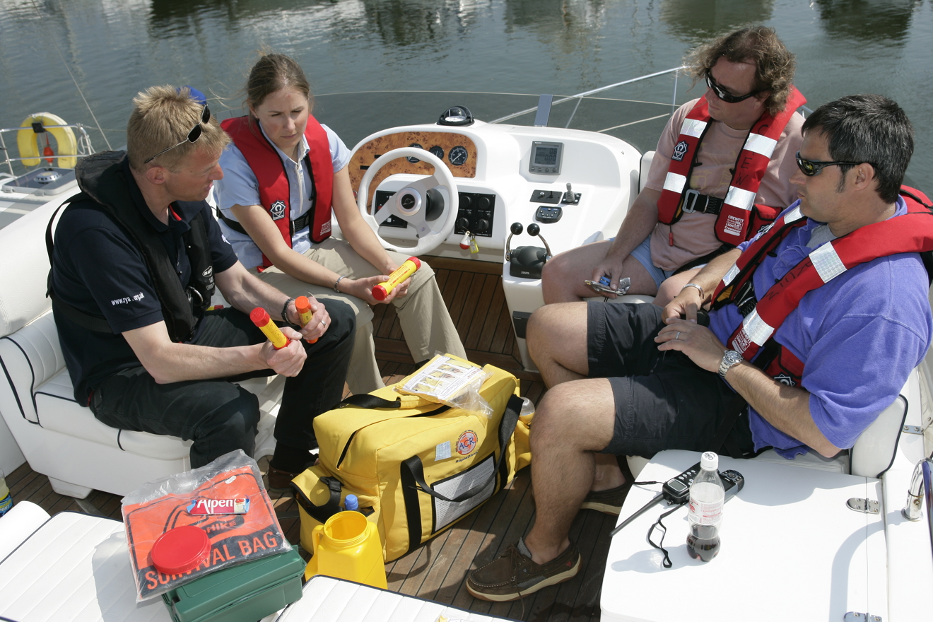 Instructor packing first aid kit on boat