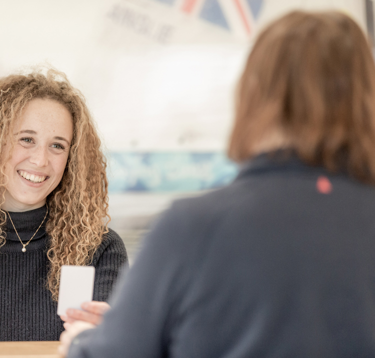 Woman being handed keycard