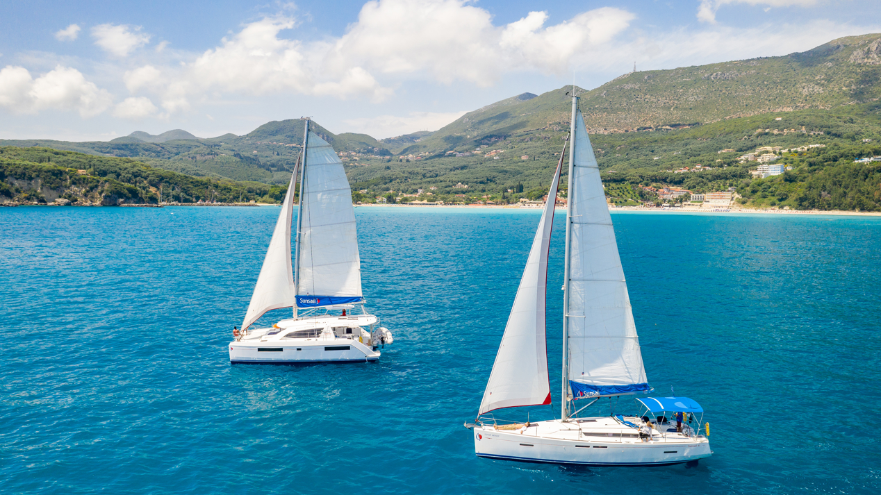 two sunsail yachts sailing in clear blue waters