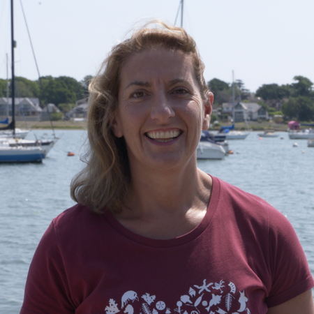 Profile image of woman stood in front of water