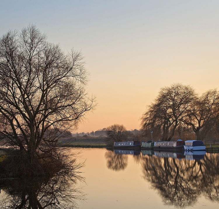Narrowboats on canal at sunset 