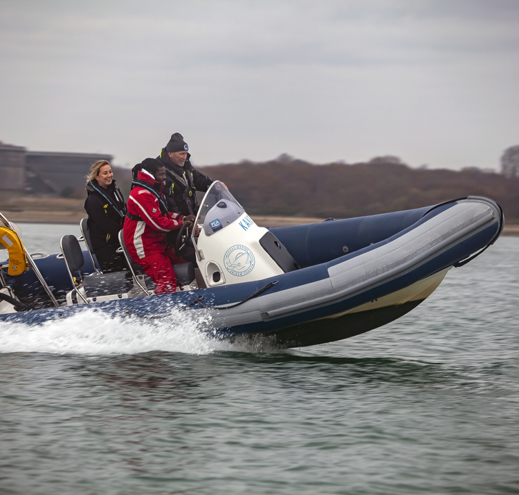 two students using a rib with their instructor