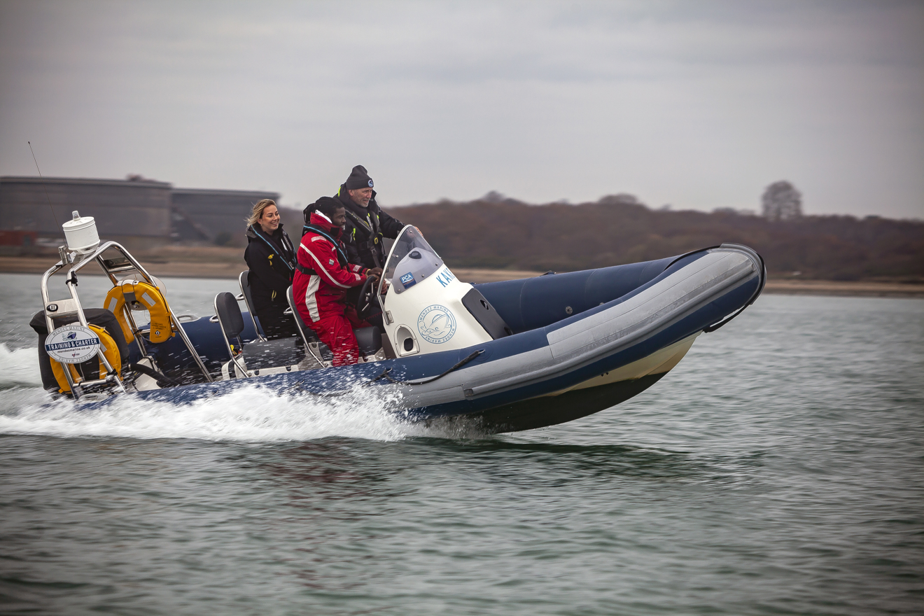two students using a rib with their instructor