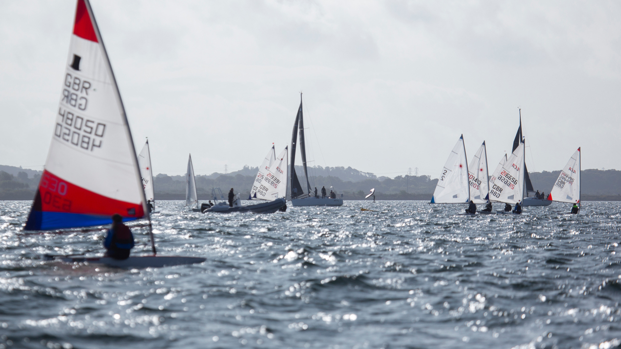 Dinghies sailing across sparkling waters