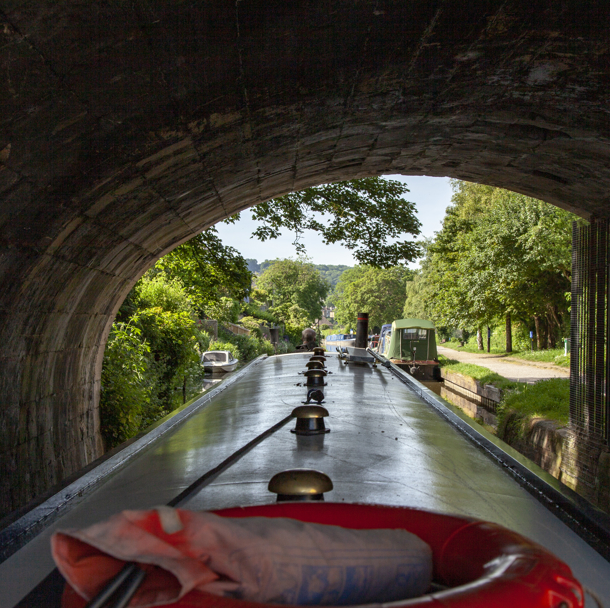 Canal boat passing through tunnel on inland waterways