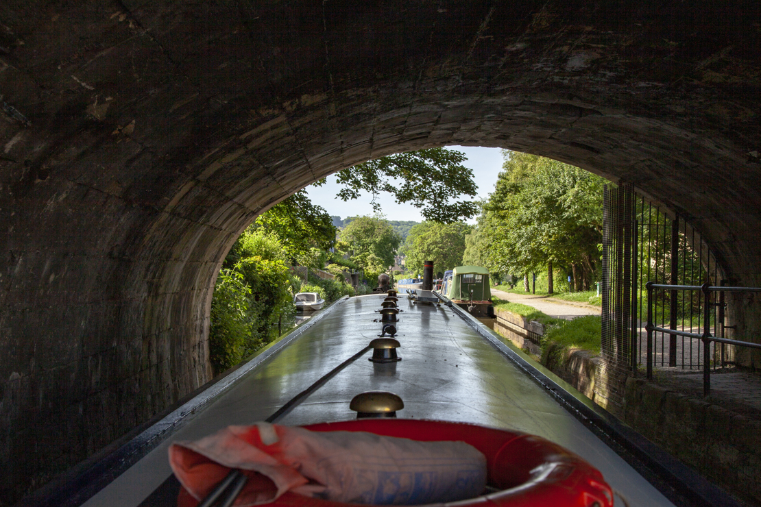 Canal boat passing through tunnel on inland waterways