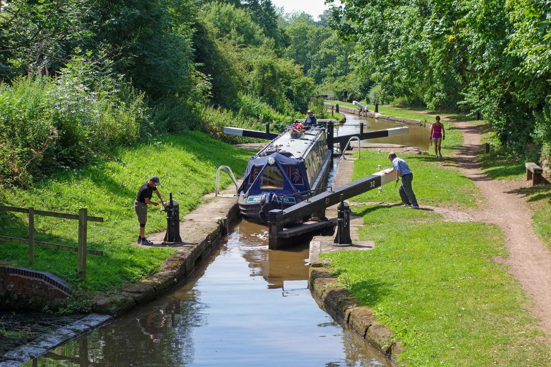 boaters operating a canal lock on the inland waterways 