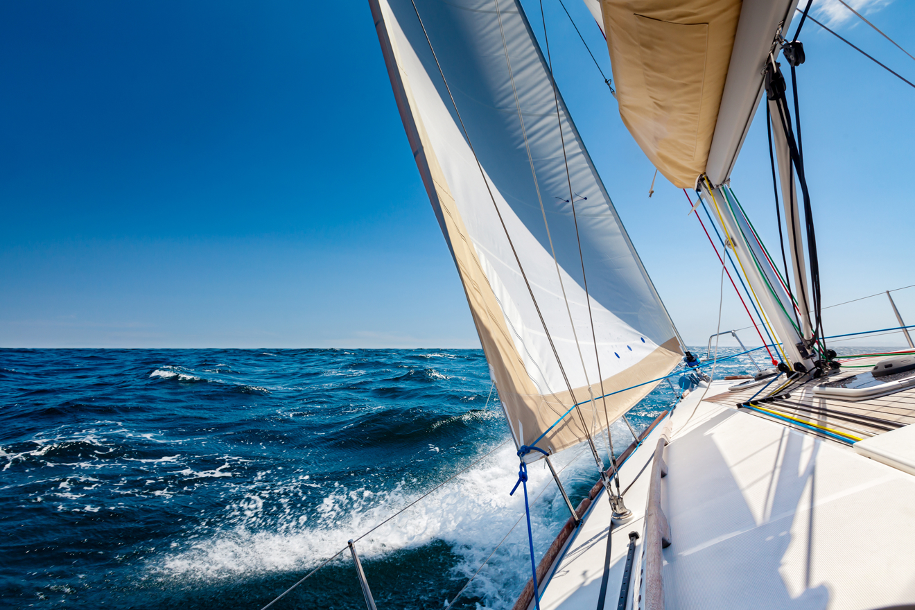 boat sailing safely through blue waters