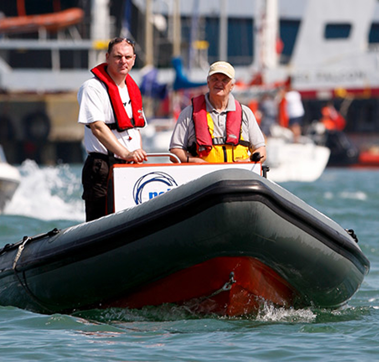 2 people driving a rib
