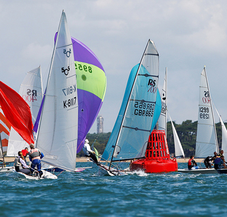 colourful dinghies navigating bright blue waters